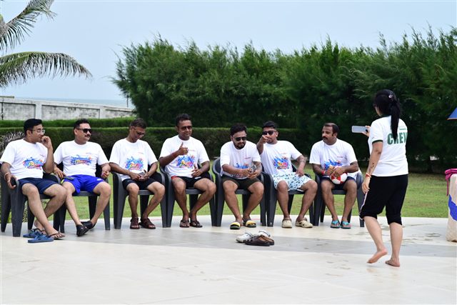 Team seated outdoors for a game session