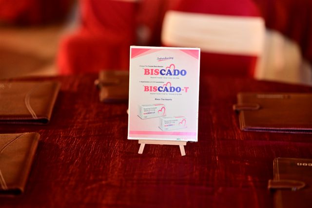 Branded tabletop standee on a red cloth
