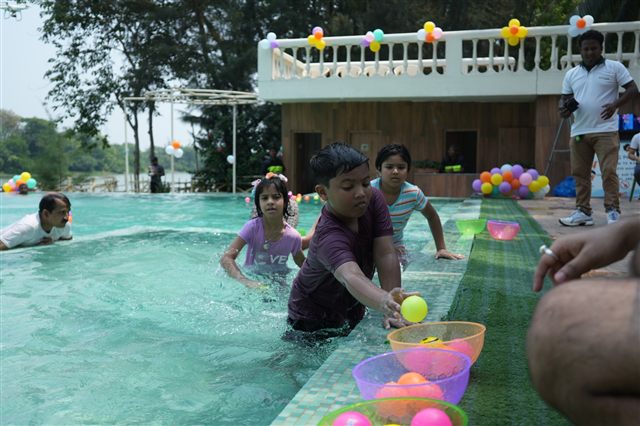 Children playing ball games in the pool